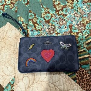 Coach navy blue wristlet with cute designs signature C